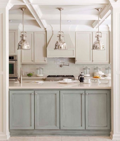 industrial chrome or polished nickel lighting in a gray and blue kitchen