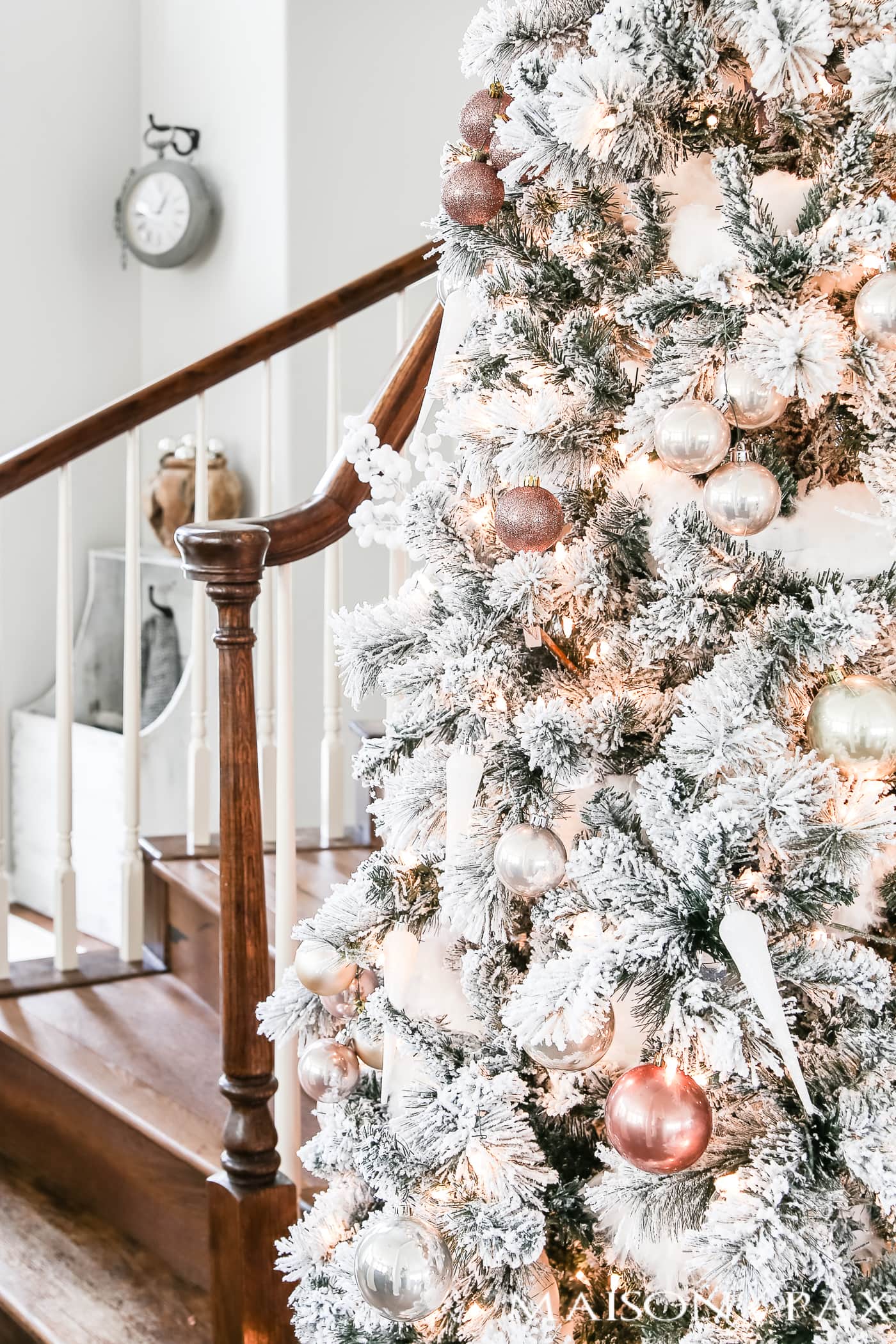 blush and copper and icicle white ornaments on a full flocked tree #flockedtree
