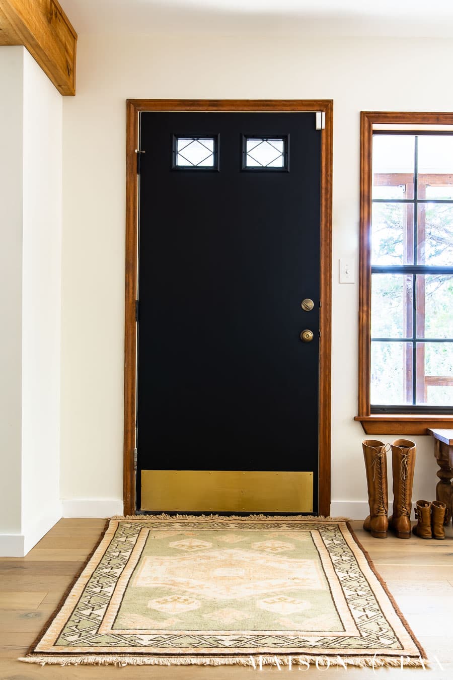 entry way with black door and vintage rug and security door sensor | Maison de Pax