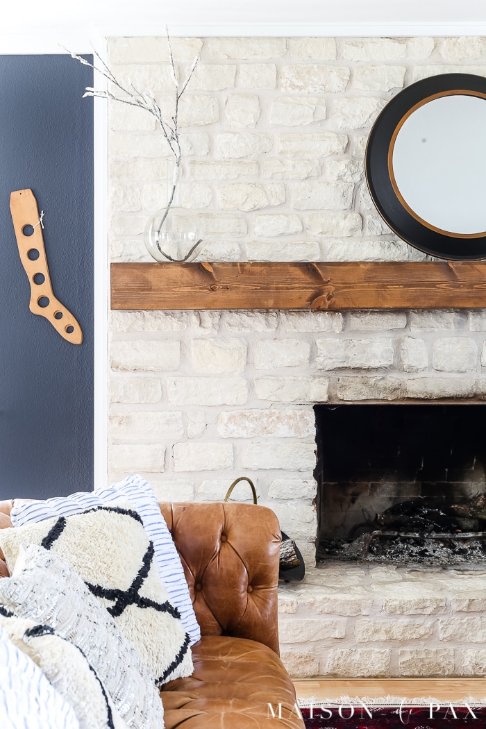 limestone fireplace with wood mantel
