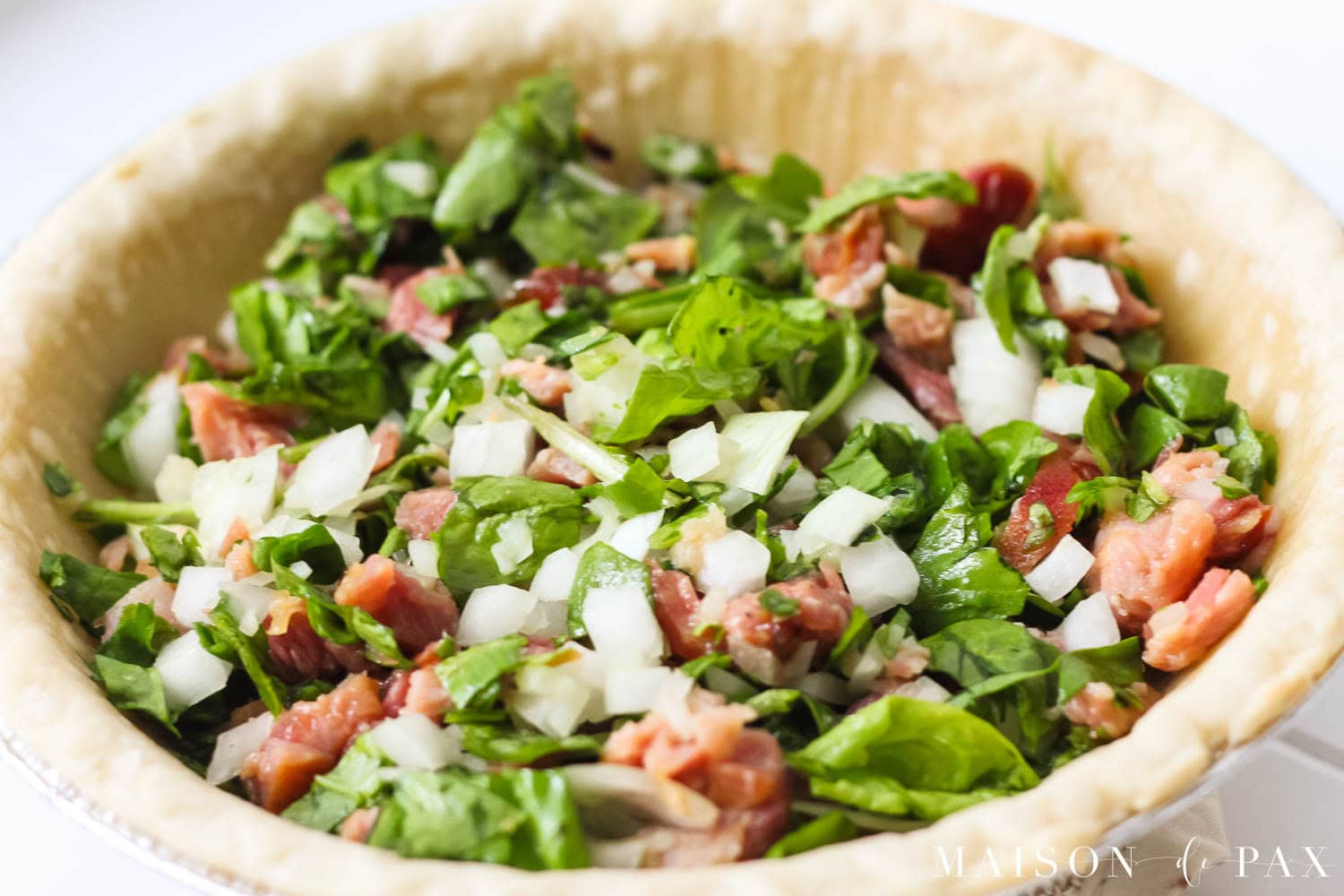 chopped ham, spinach, and onions in a pie crust