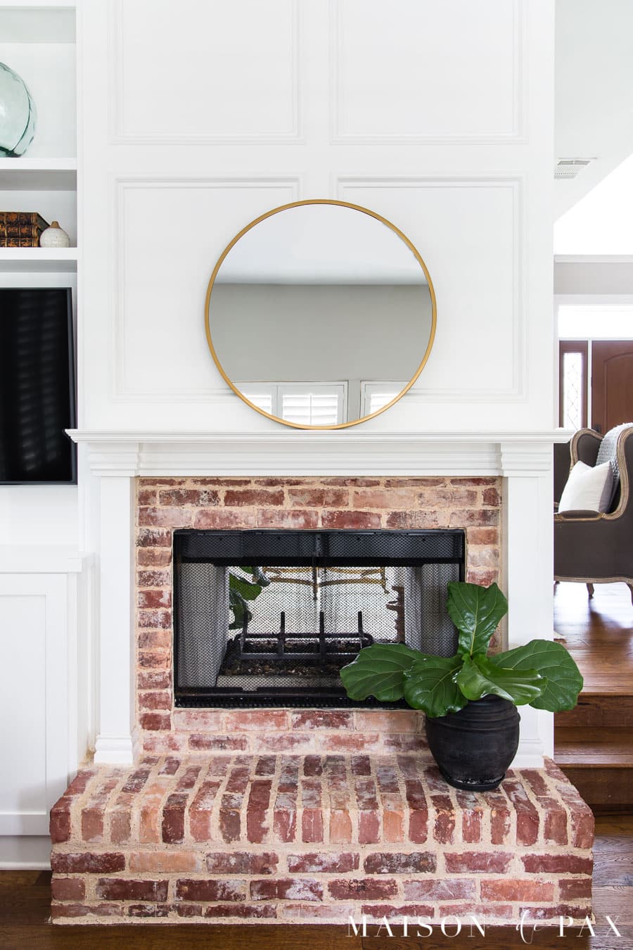 round mirror above mantel and fiddle leaf fig on hearth | Maison de Pax