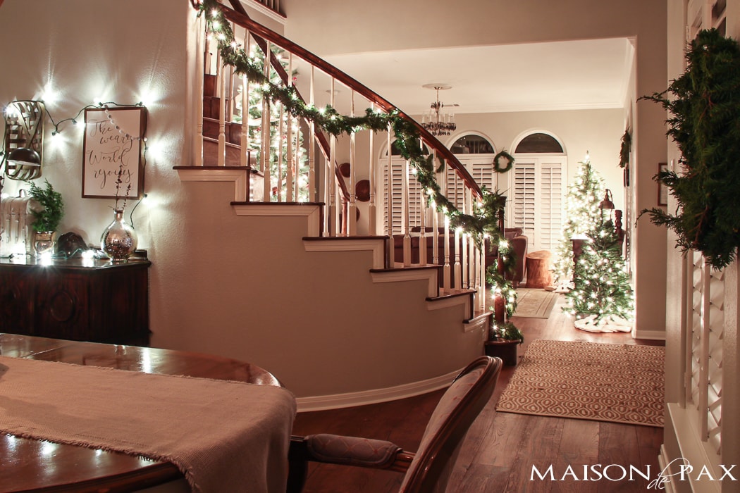 globe lights above buffet and lighted garland on stairs - lovely Christmas evening!