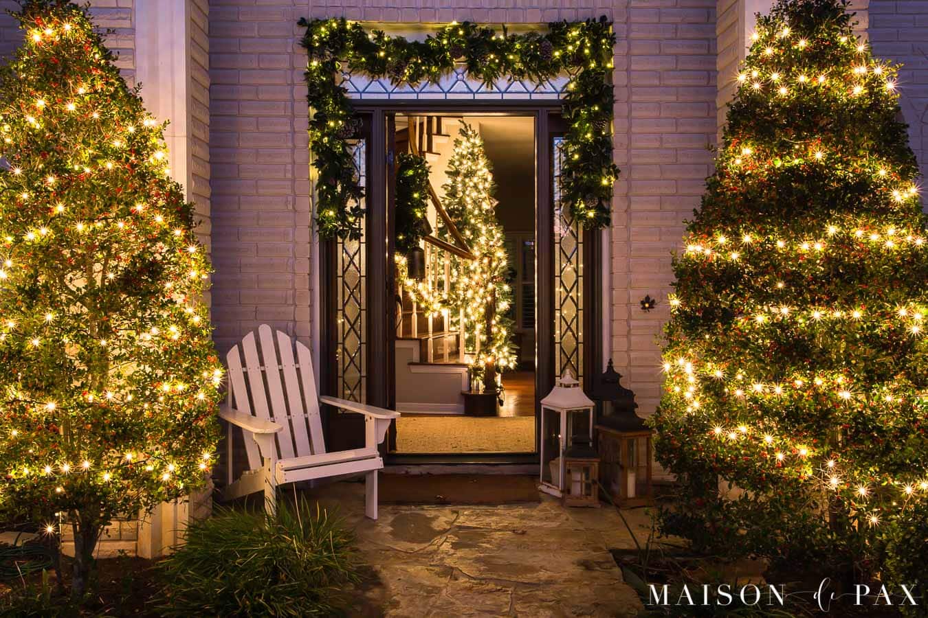 home lit up at night with Christmas lights | Maison de Pax