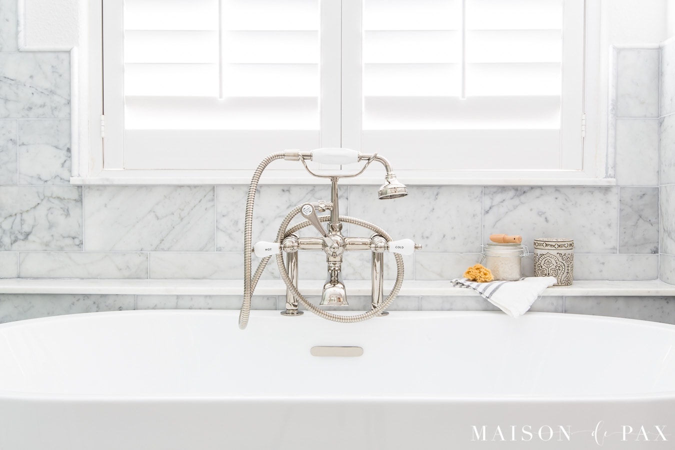 marble tub ledge under window behind freestanding tub | Maison de Pax
