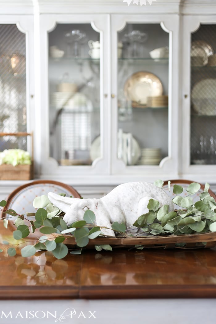 What a cute, simple idea for Easter decor! Use a garden statue bunny in a basket with dried greens as a centerpiece for your table | aiweb9ygdry.cmersite.com