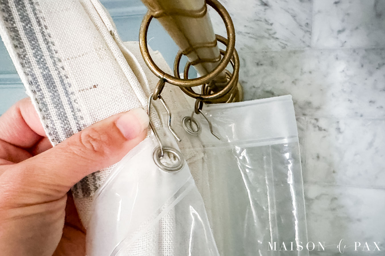 using curtain rings and curtain hooks to install regular pinch pleat curtains as a shower curtain