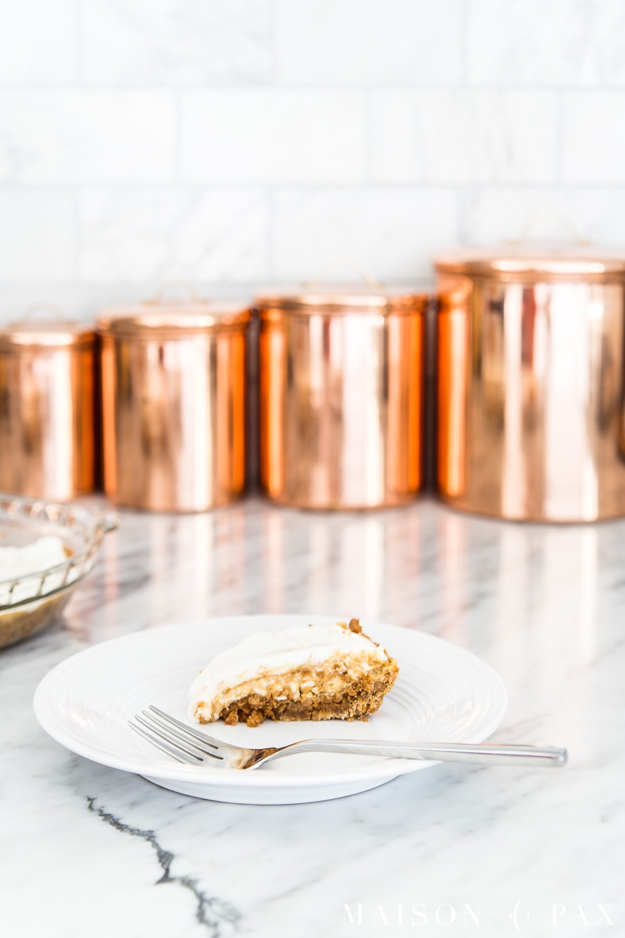 pumpkin cheesecake with sour cream topping on white plate | Maison de Pax