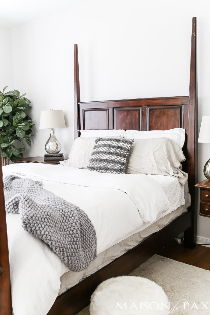 white bedding and dark gray accents- Maison de Pax