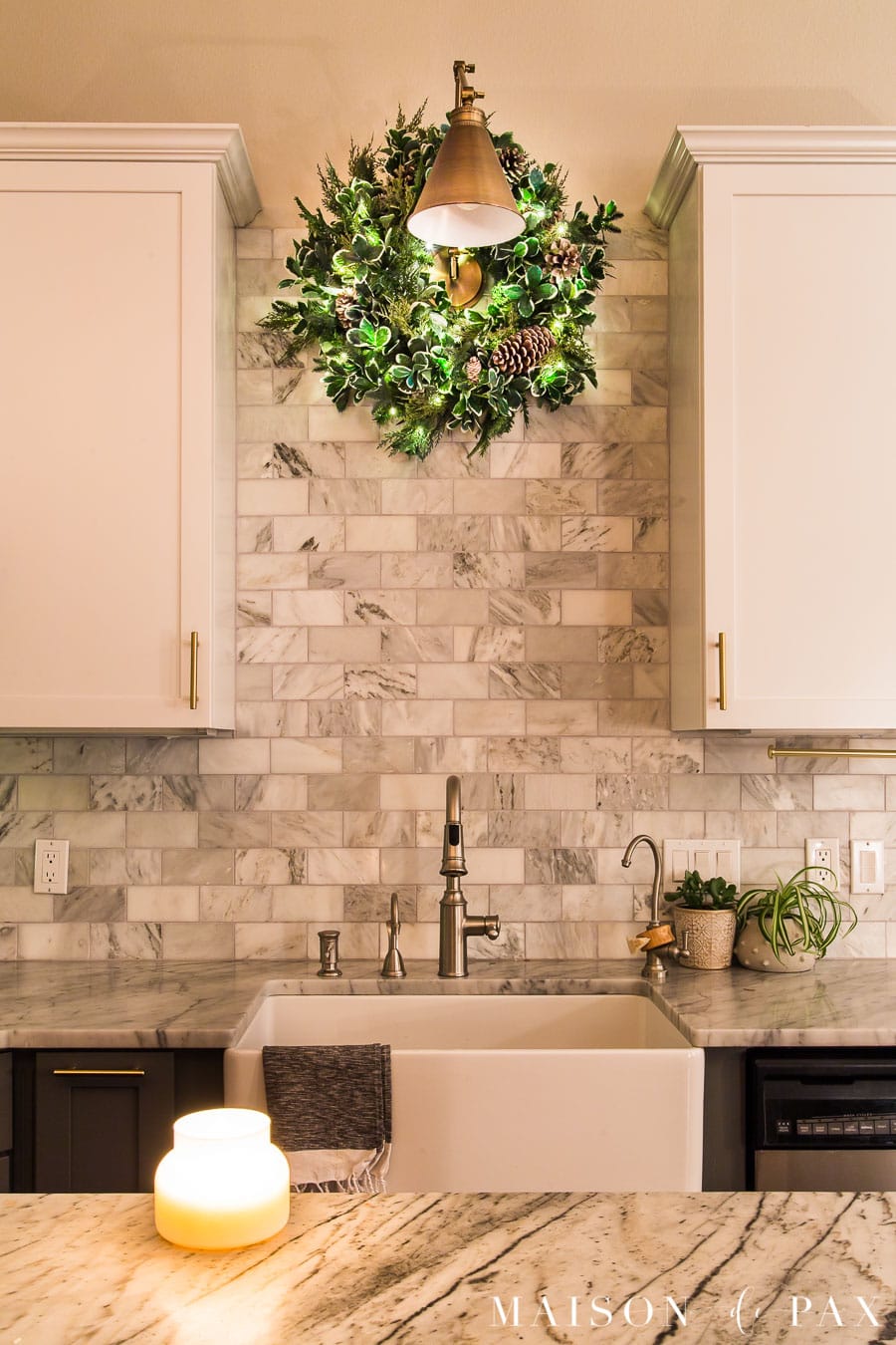 wreath with twinkle lights above kitchen sink | Maison de Pax