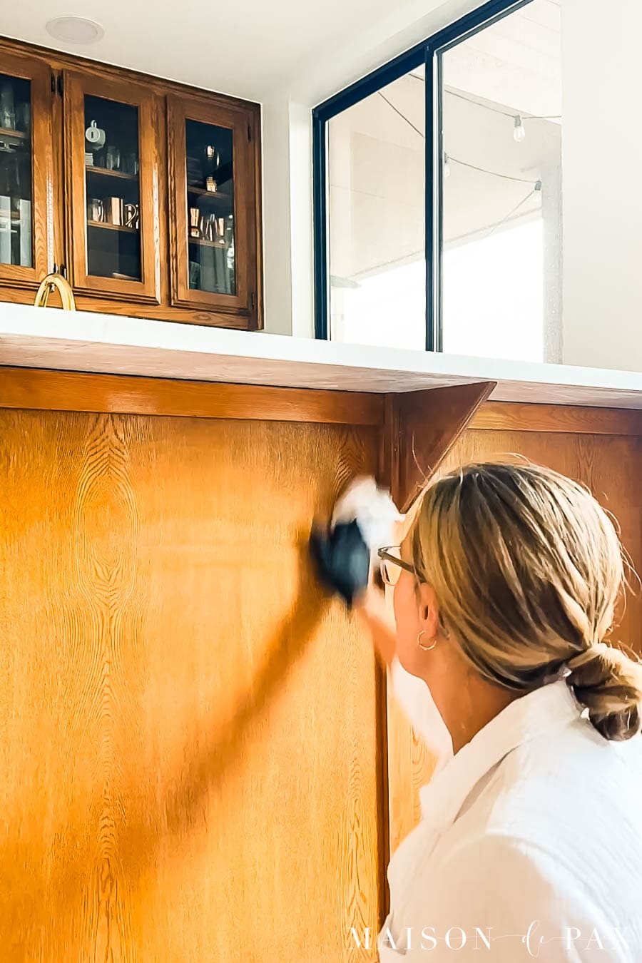 wipe liquid sandpaper (aka deglosser) on cabinetry before painting