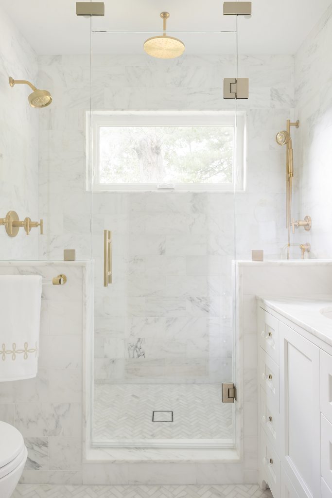 marble walk in shower with gold hardware and gold shower faucets