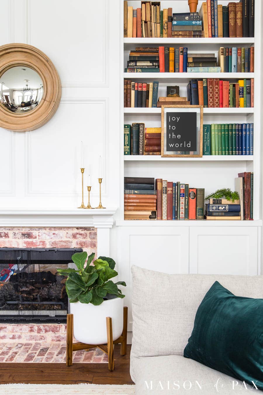 bookcase with antique books and fiddle leaf fid | Maison de Pax