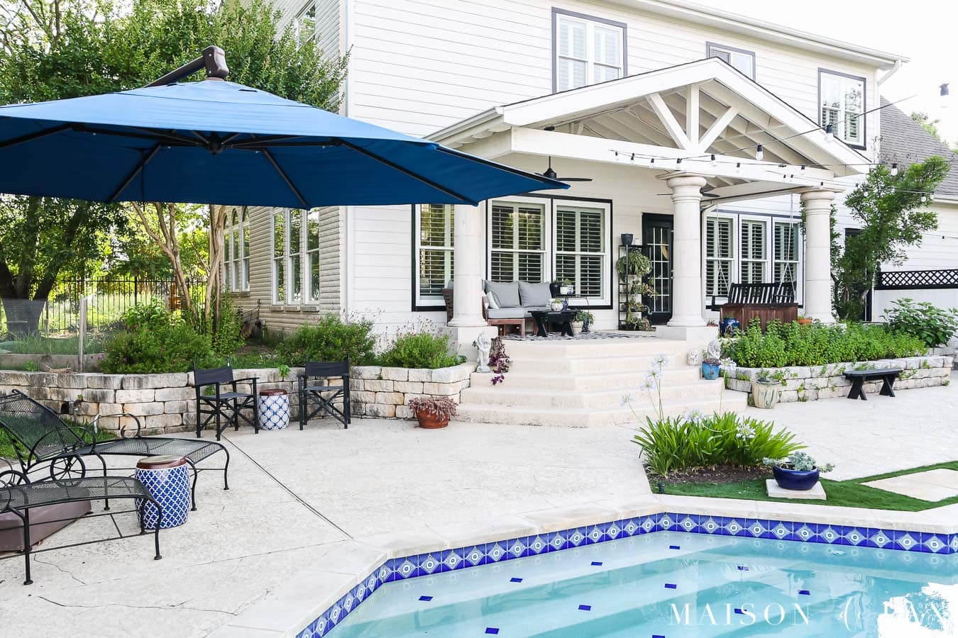 large cantilever umbrella beside a backyard pool