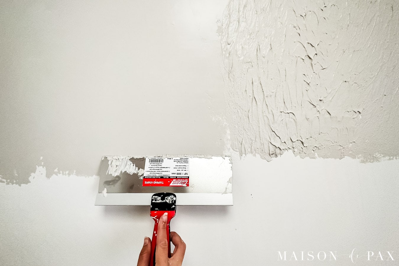 skim coating walls with drywall mud and trowel