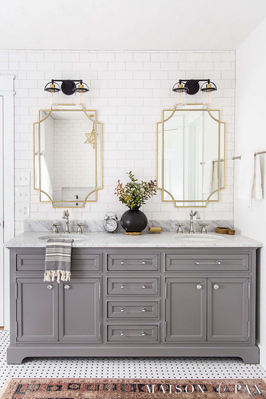gray vanity with storage and marble top two sinks