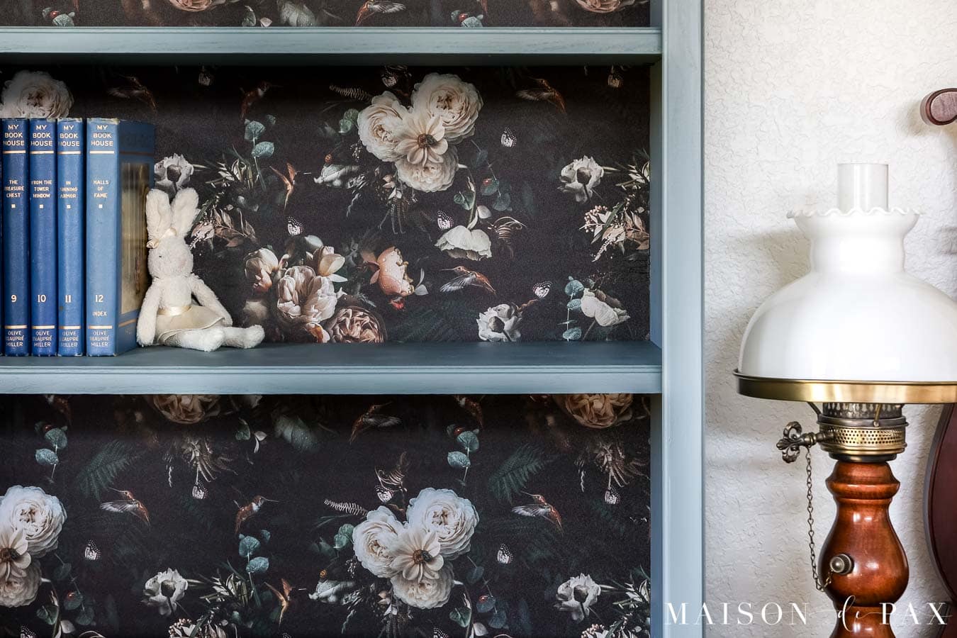 bookshelves with wallpaper backing