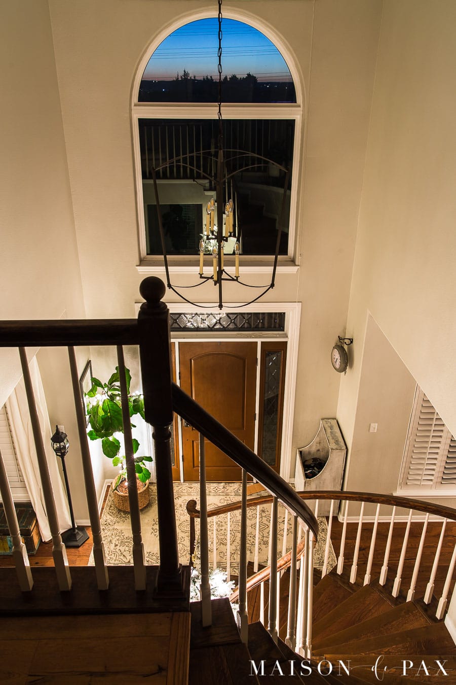curved staircase lit by Christmas lights | Maison de Pax