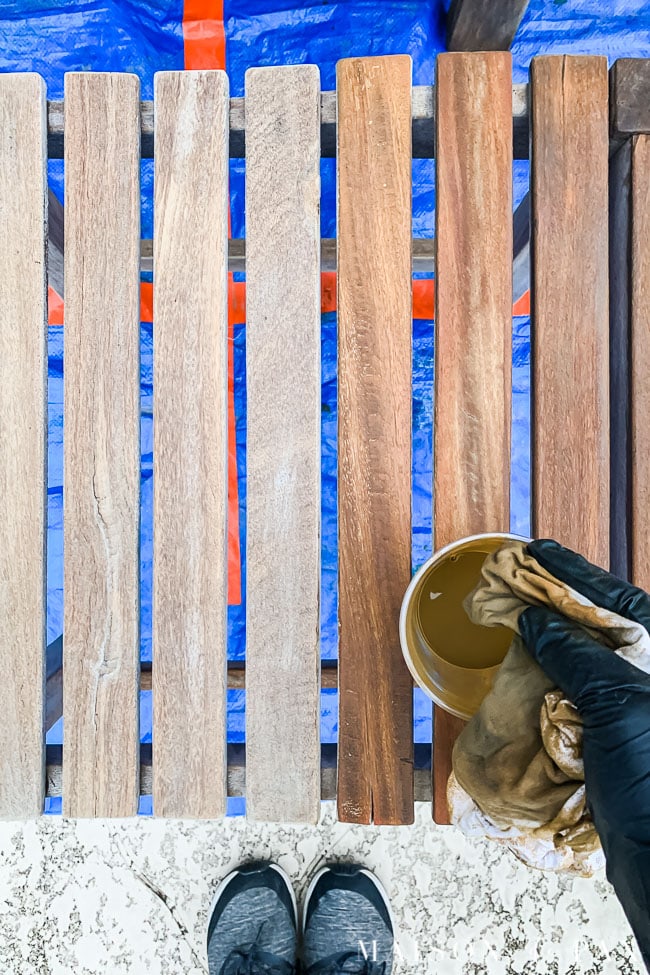 applying teak protector to raw teak wood