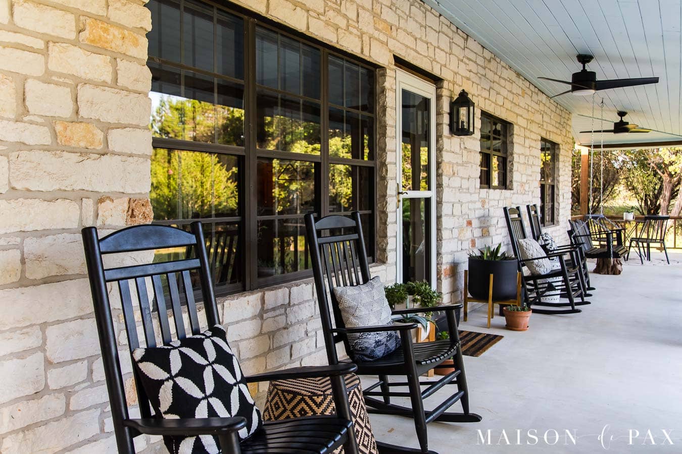 black rocking chairs with black and white throw pillows | Maison de Pax