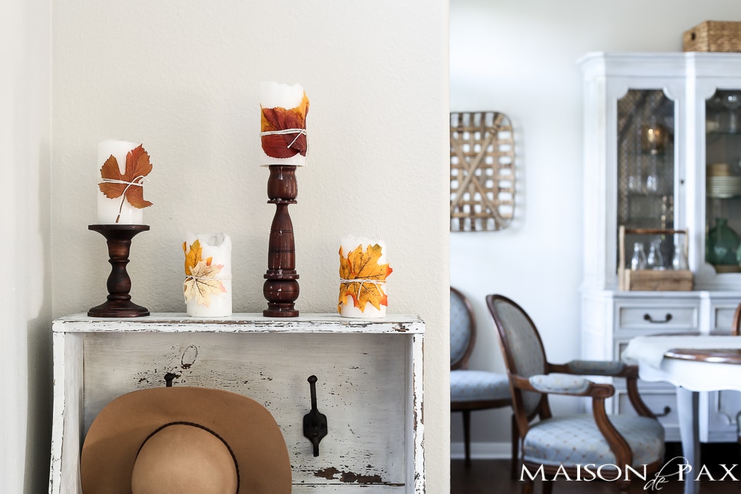 cute fall craft idea: wrap pillar candles in fall leaves and twine