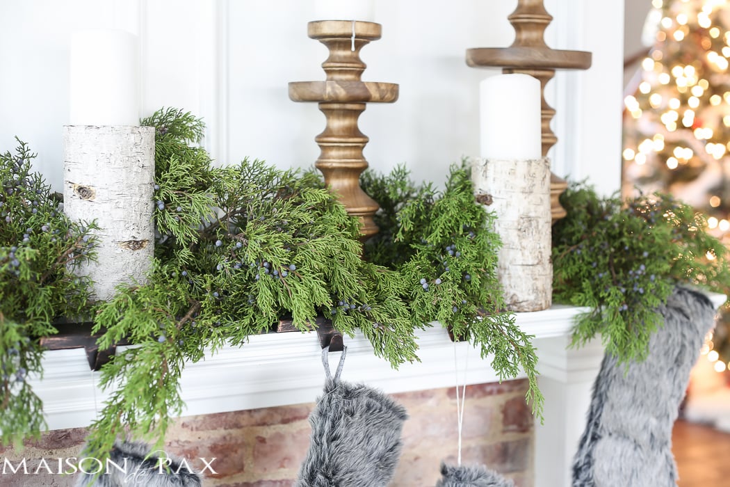 Winter Woodland Christmas Mantel: Looking for mantel decorating ideas? Some fresh cut cedar, candlesticks, and a faux deer mount creates the perfect holiday decor.