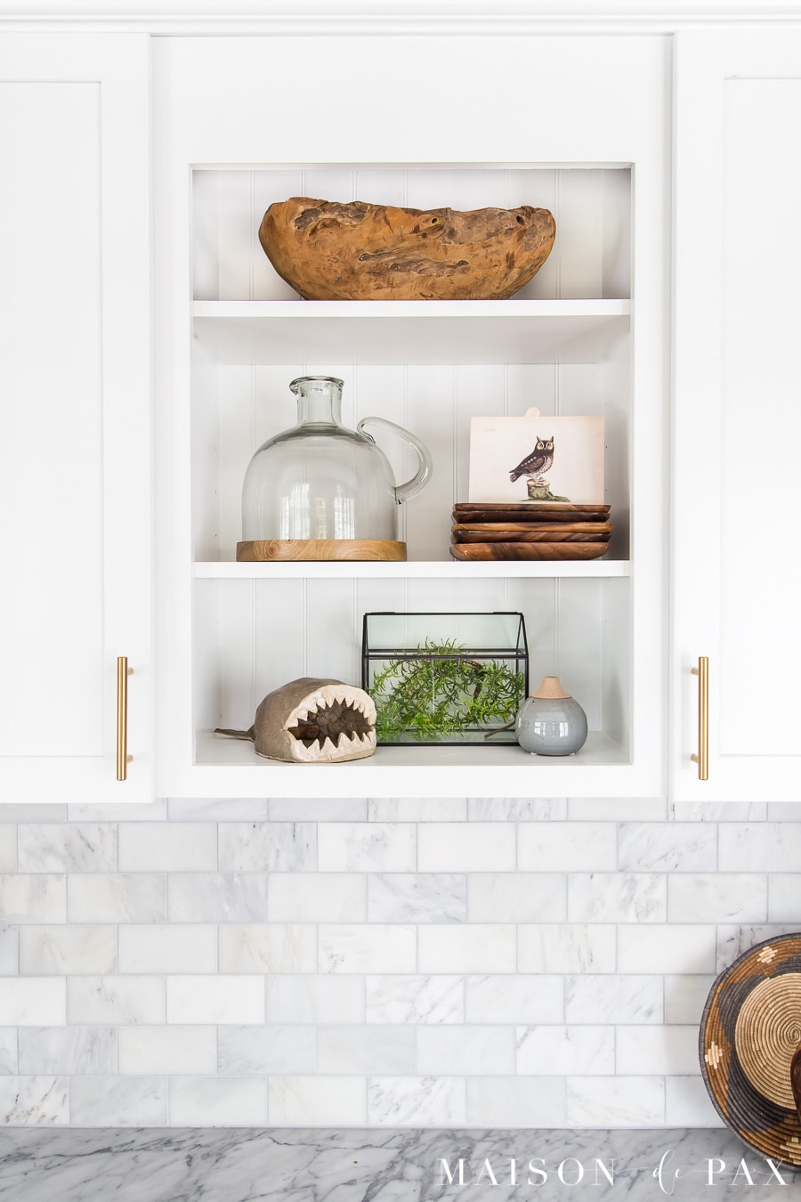 open shelves styled with wood bowl, glass terrarium, pottery, and vintage art | Maison de Pax