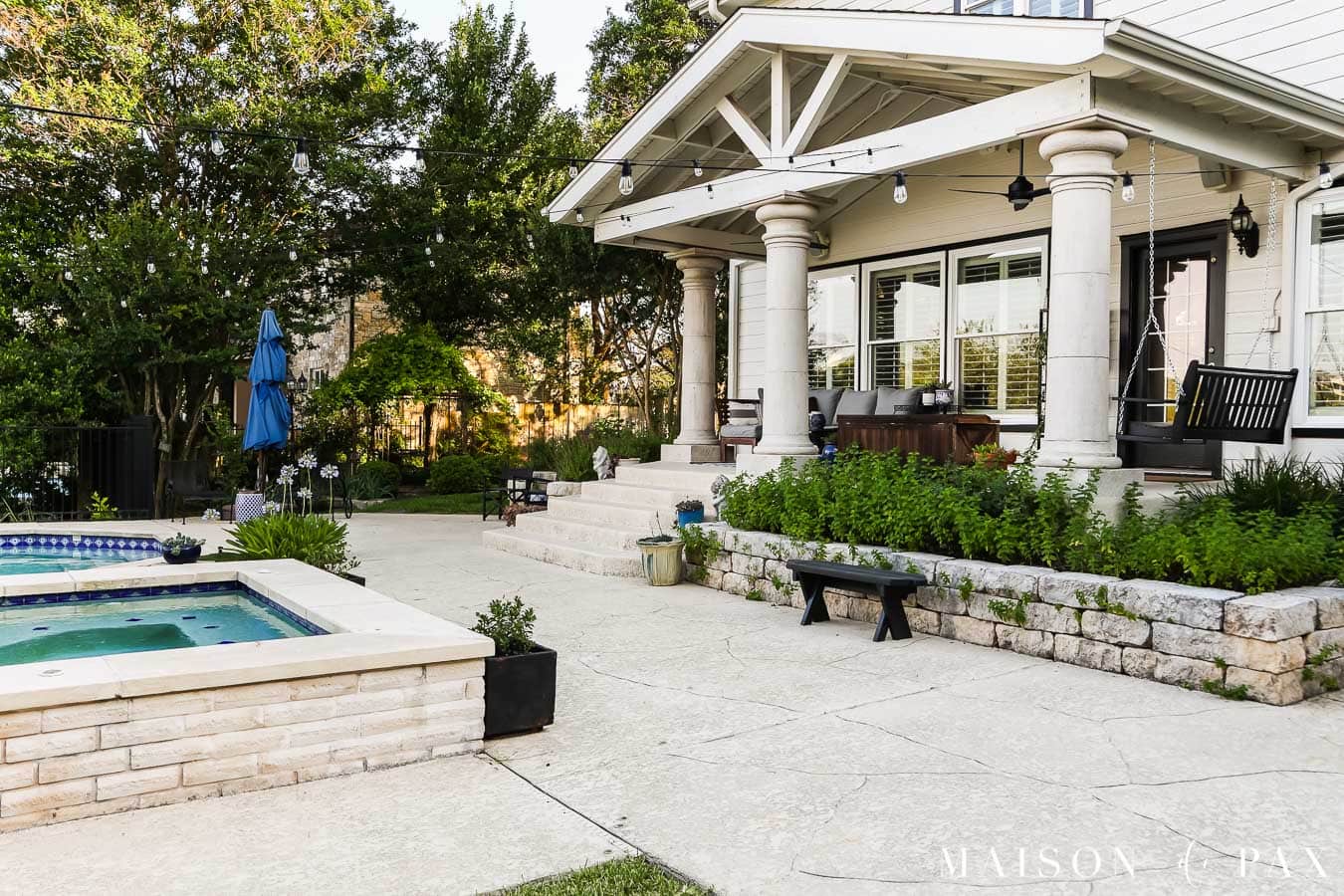 outdoor pool and patio with string lights