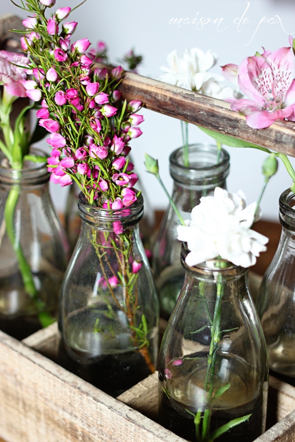 This stunning carrier made from reclaimed wood holds 6 antique milk bottles and makes the perfect rustic yet elegant piece of decor!