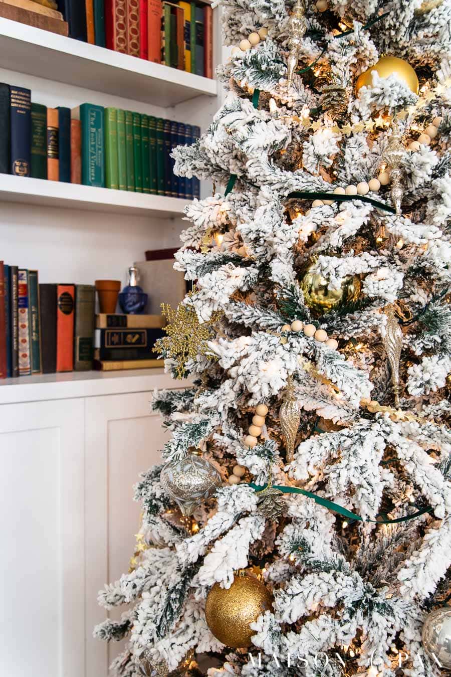 flocked Christmas tree with wood and metallic ornaments | Maison de Pax