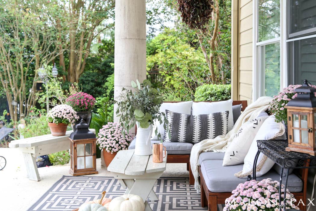 cozy fall porch with neutral textures, wooden lanterns, and pink mums- Maison de Pax