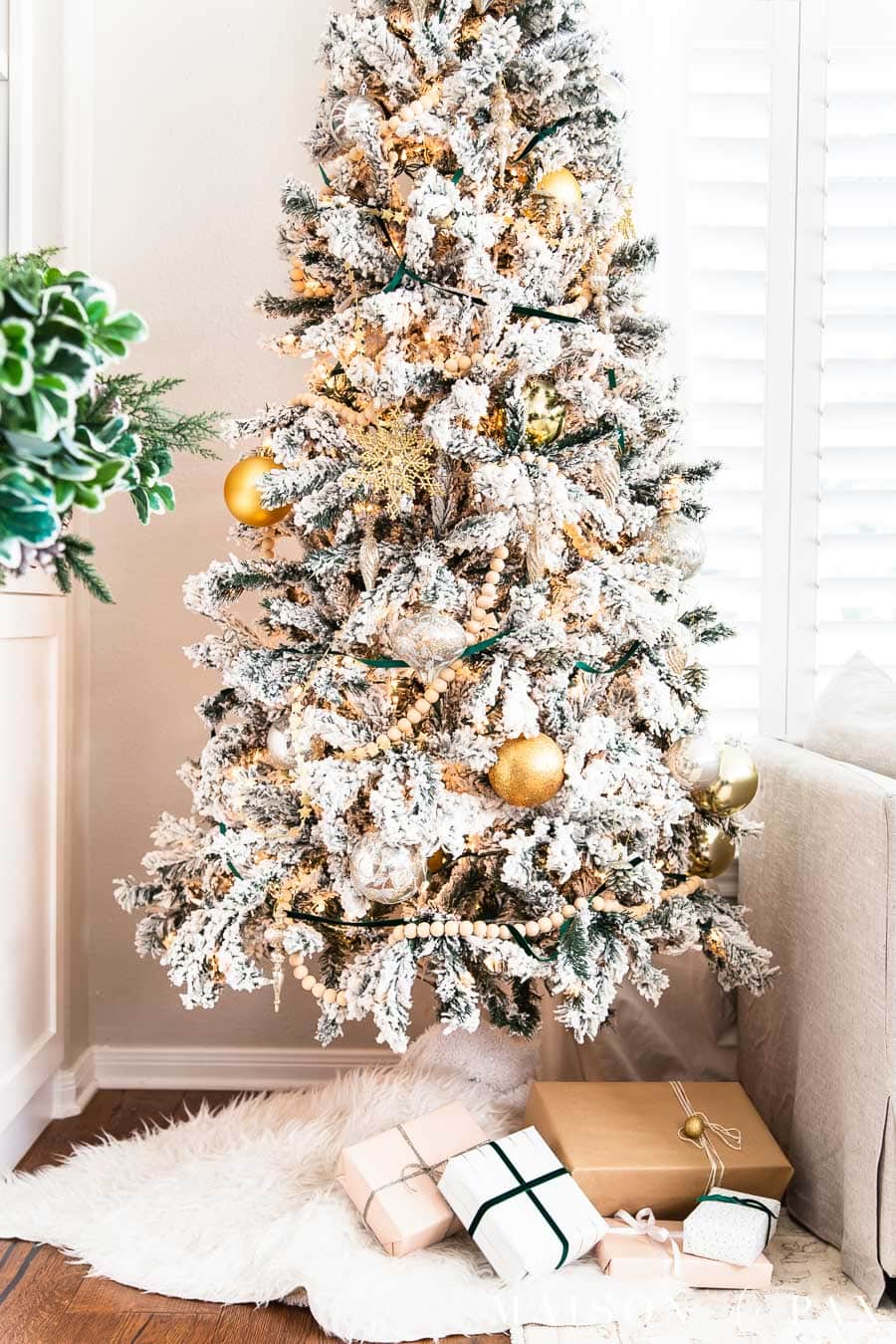slim flocked tree with wood bead garland | Maison de Pax