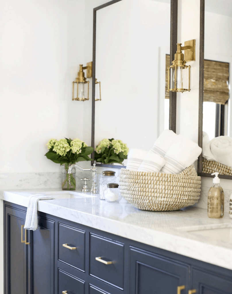 navy vanity with marble countertops