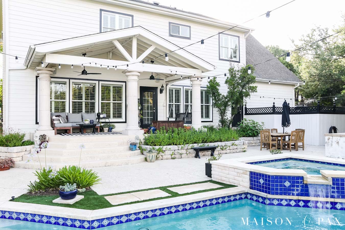 black and white house with pool with blue tile