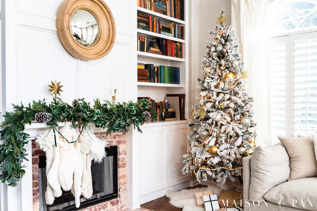 white flocked tree beside mantel with greenery | Maison de Pax
