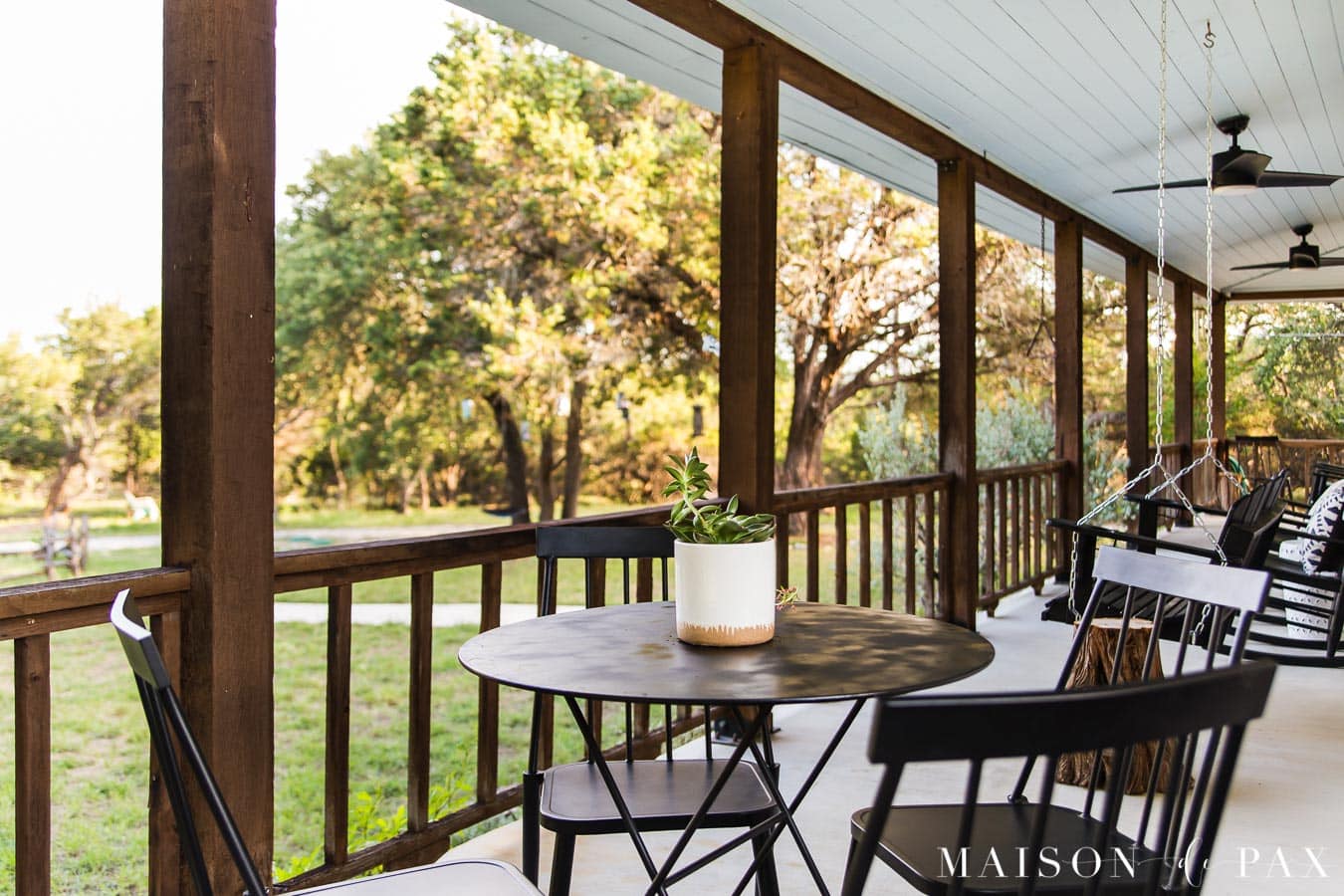 bistro table and metal chairs on front porch | Maison de Pax