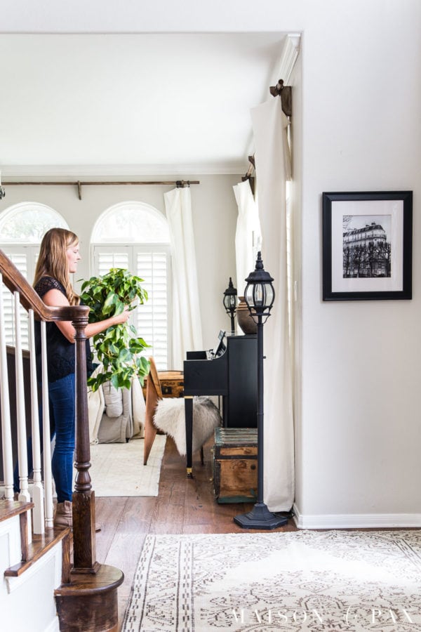 woman with philodendron in classic gray entryway with stairwell | Maison de Pax