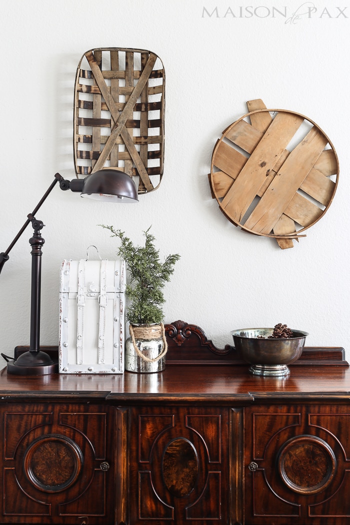 tobacco basket and bushel lid provide beautiful rustic contrast to a more formal dark wood buffet | aiweb9ygdry.cmersite.com