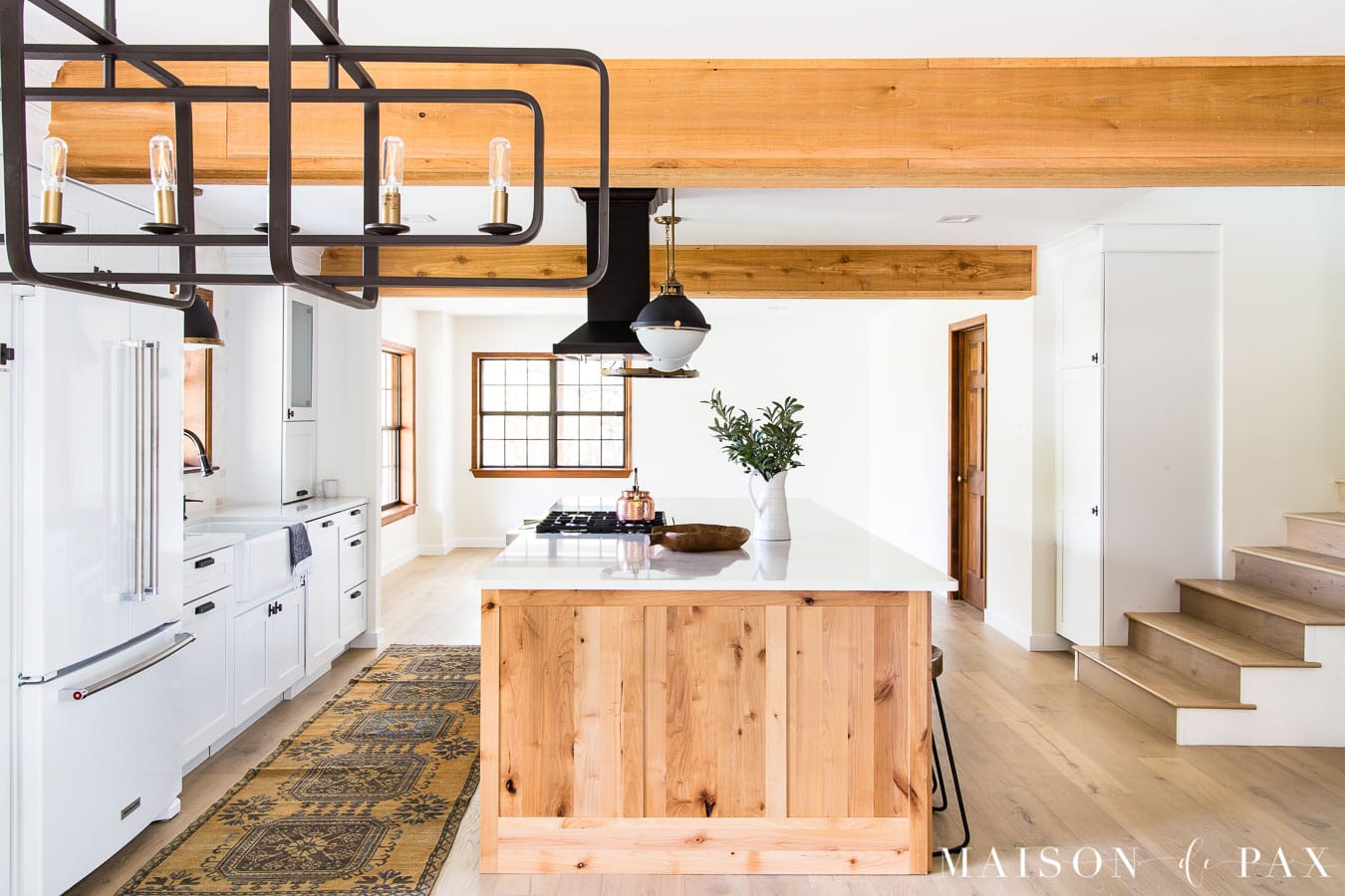 big rustic wood island in kitchen with beams | Maison de Pax