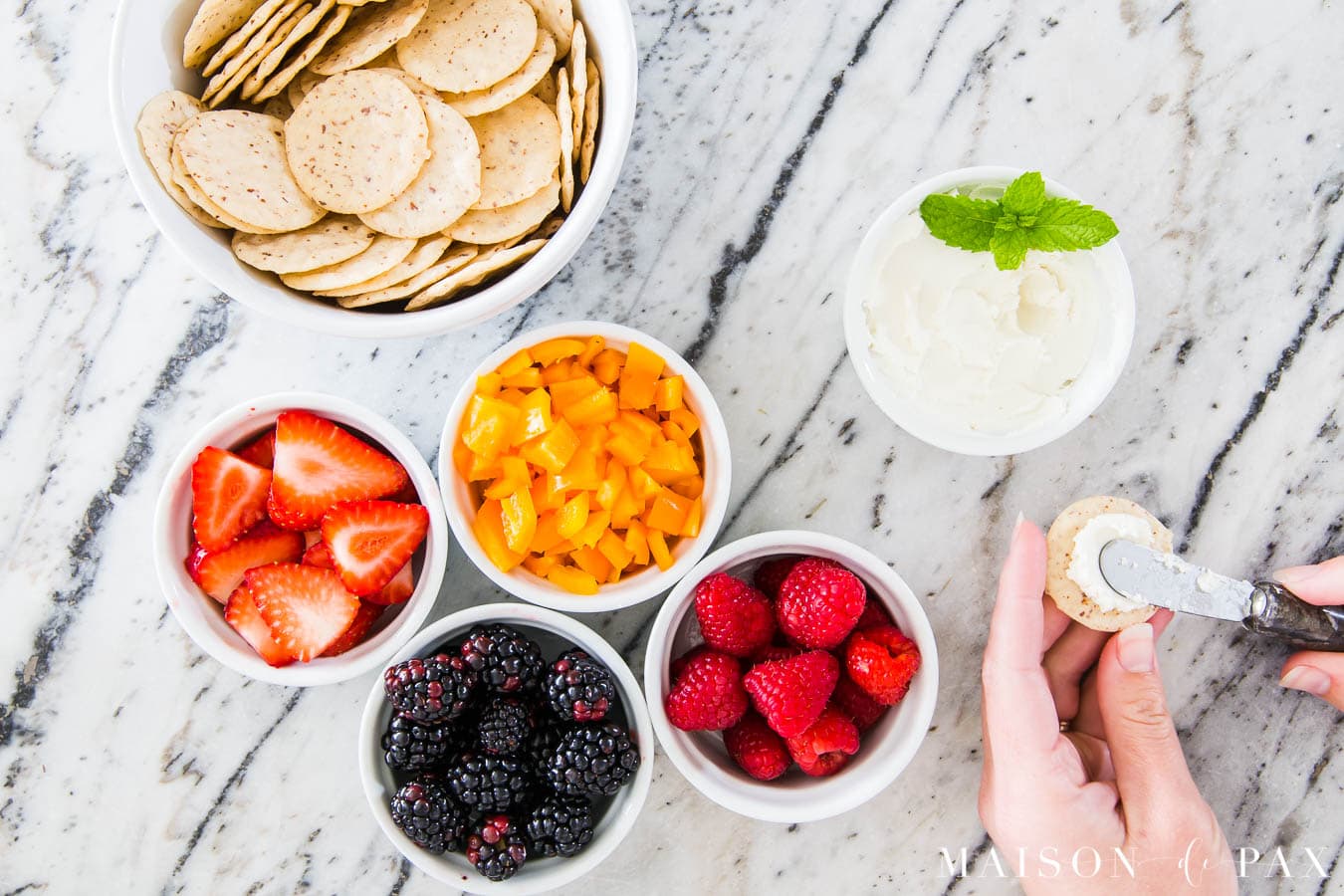 crackers, cheese, and fruit beautifully styled on a marble counter | Maison de Pax