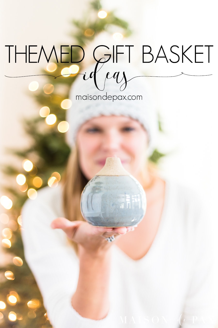 woman with gift in hand in front of Christmas tree | Maison de Pax