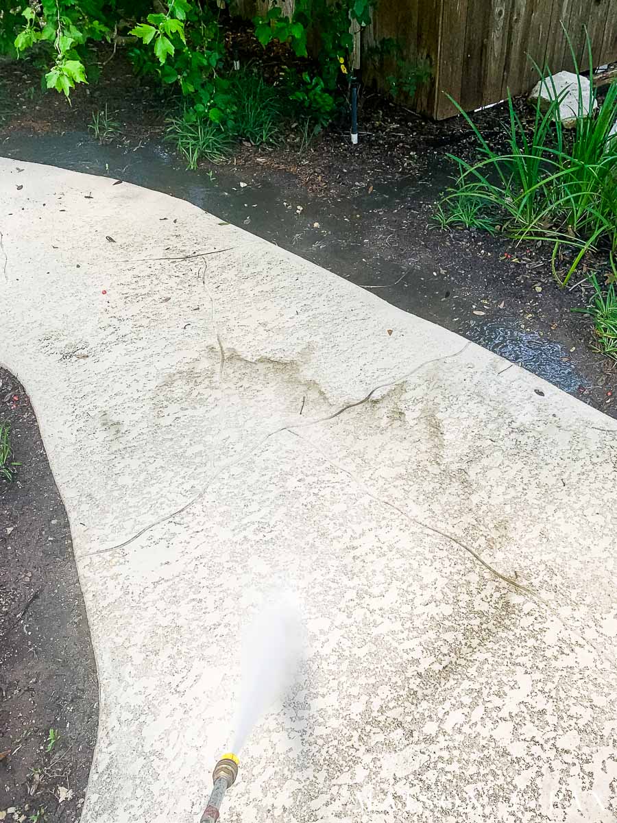 pressure washer washing away dirt from a sidewalk | Maison de Pax