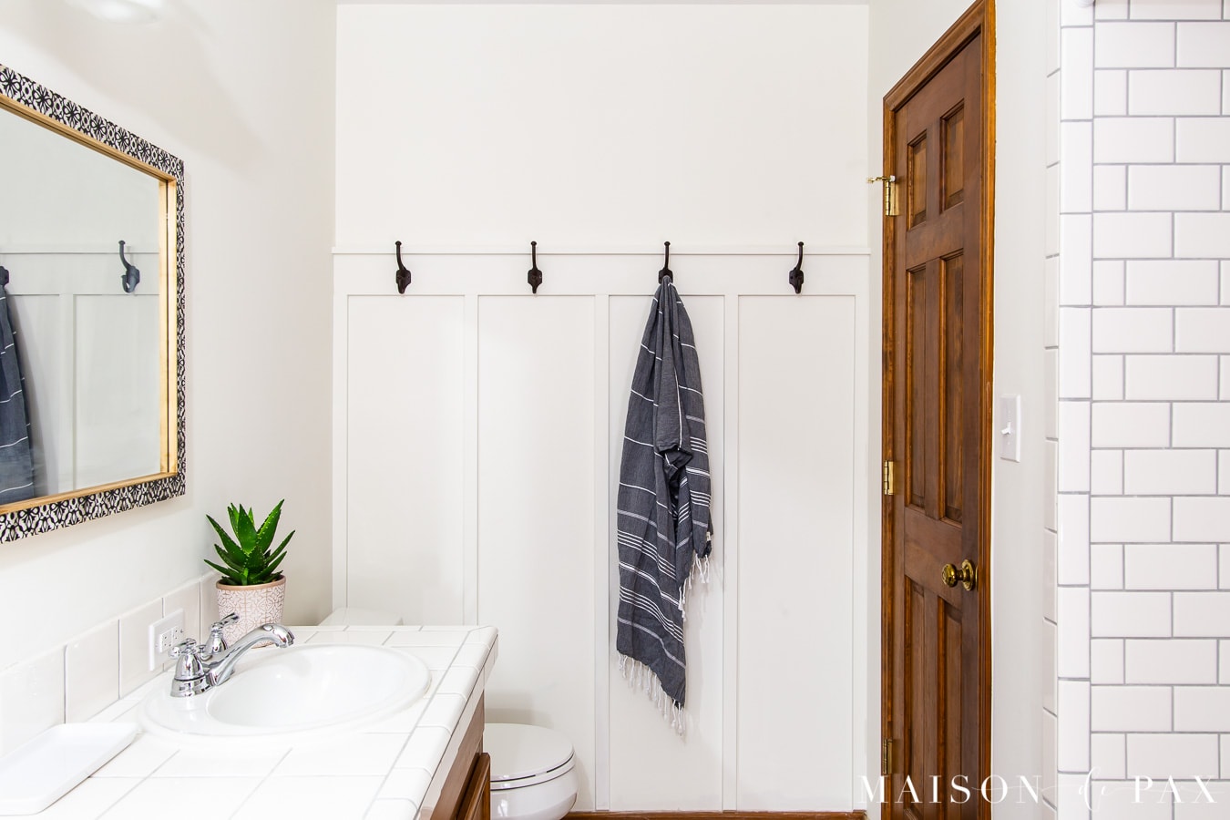 white board and batten in bathroom with wood vanity and doors | Maison de Pax