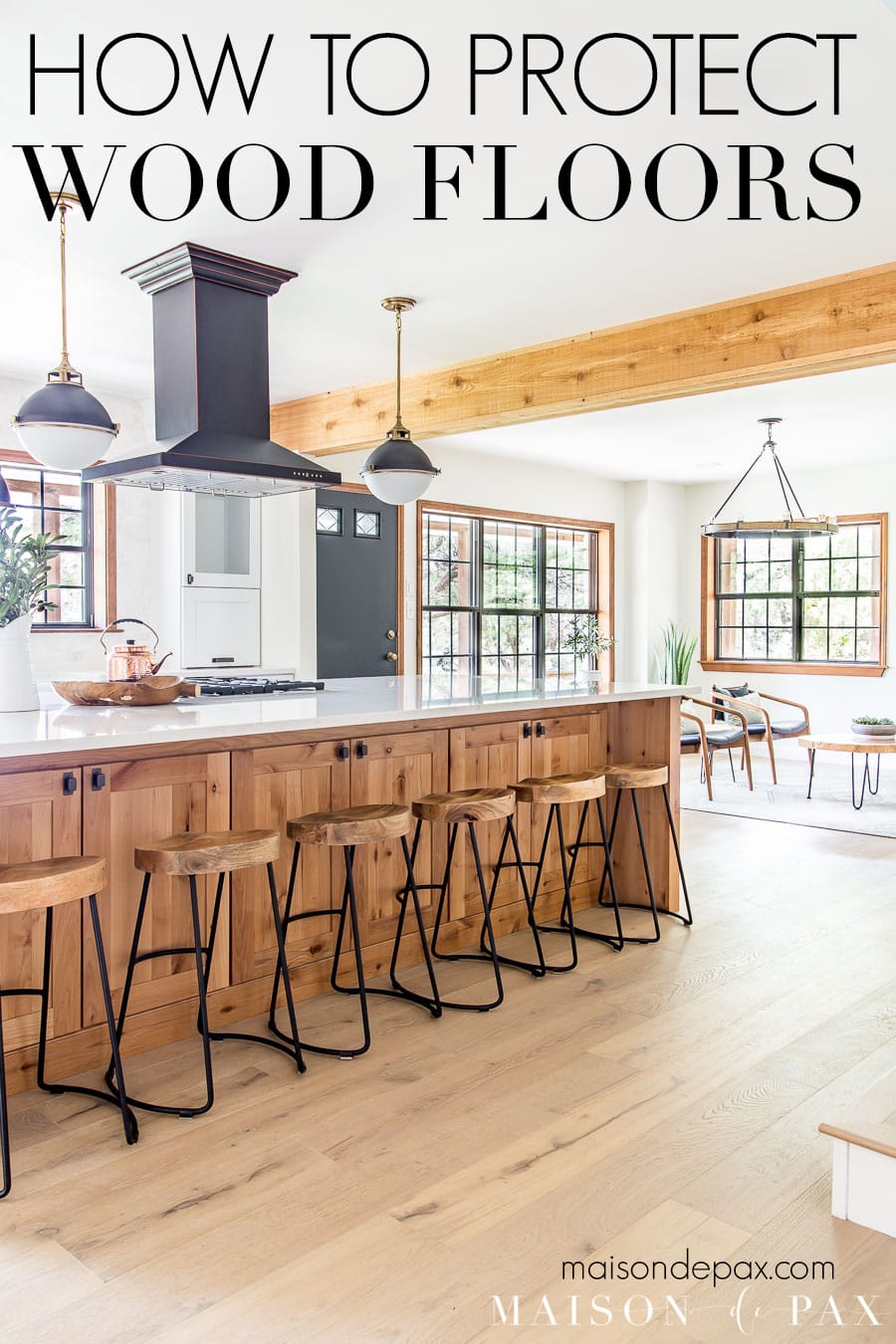 open living/kitchen with wood floors and text overlay: how to protect wood floors | Maison de Pax