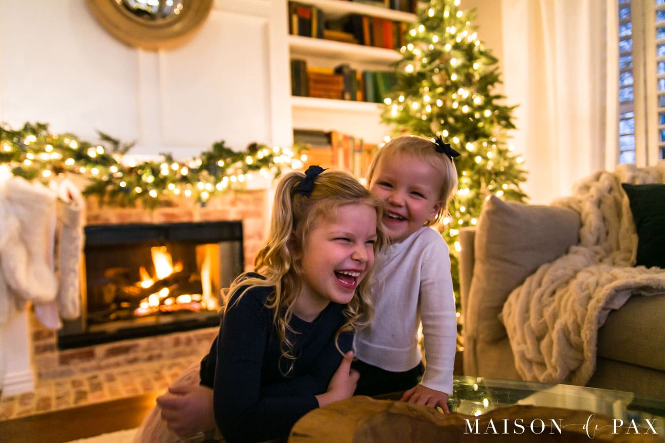girls laughing by christmas tree | Maison de Pax