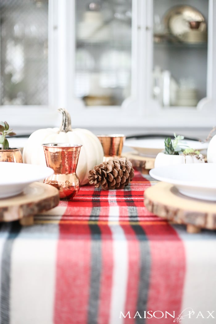 Be inspired to create a gorgeous, rustic Thanksgiving tablescape with these Thanksgiving decorating ideas! This table incorporates plaid, copper, and wood to create a beautiful yet relaxed look.