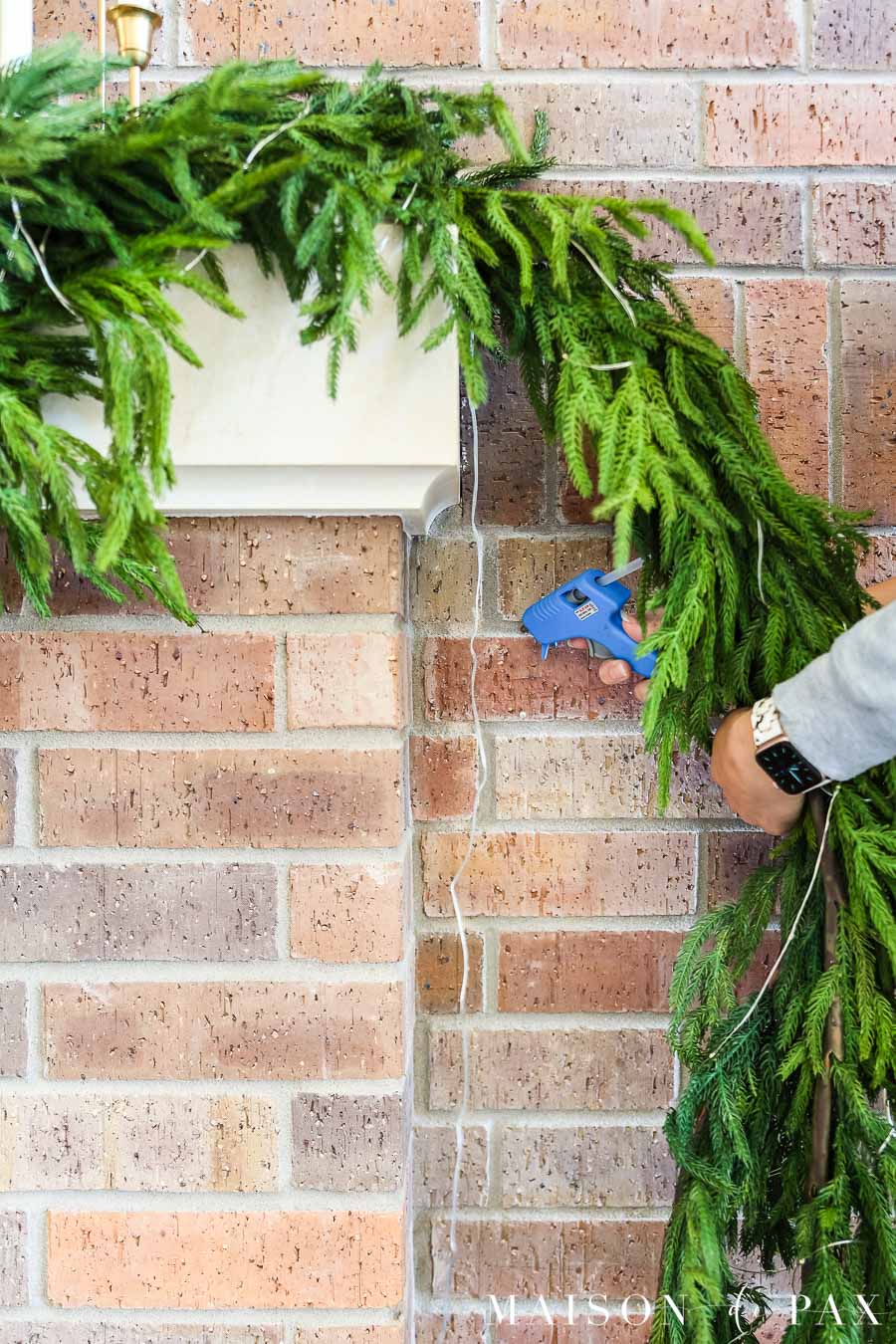 use hot glue to secure wires to brick for temporary decor