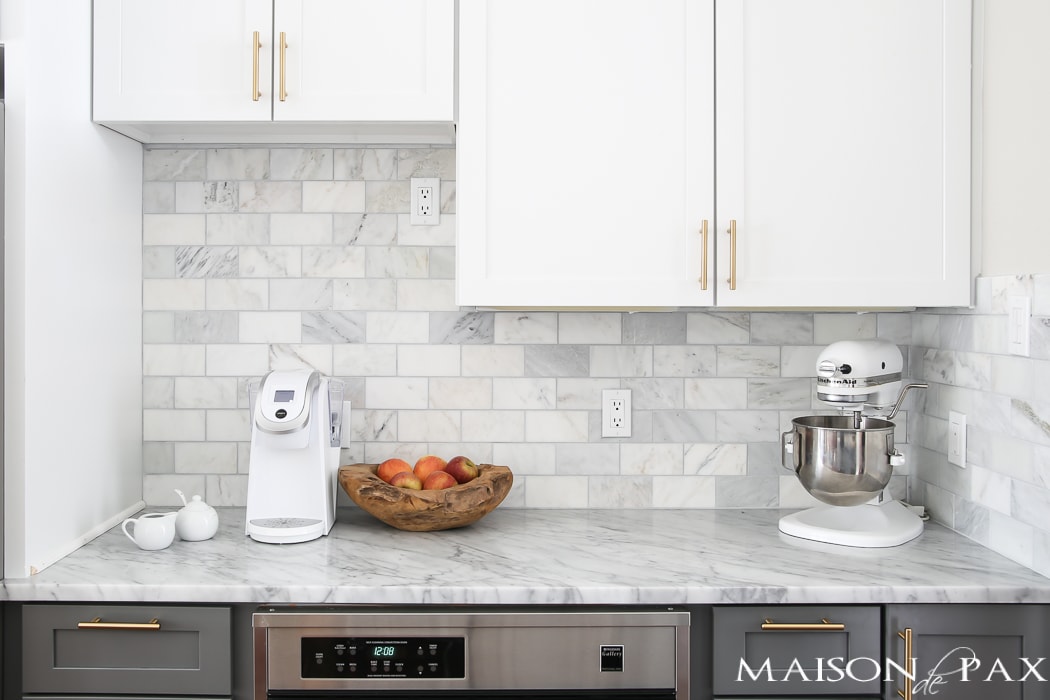 marble counters and backsplash with white appliances- Maison de Pax
