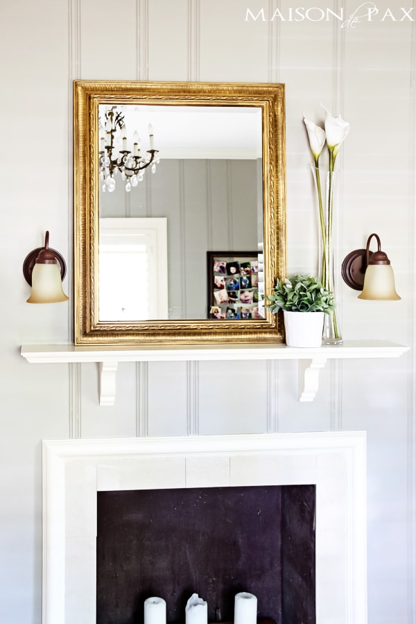 gold leaf antique mirror above vintage fireplace