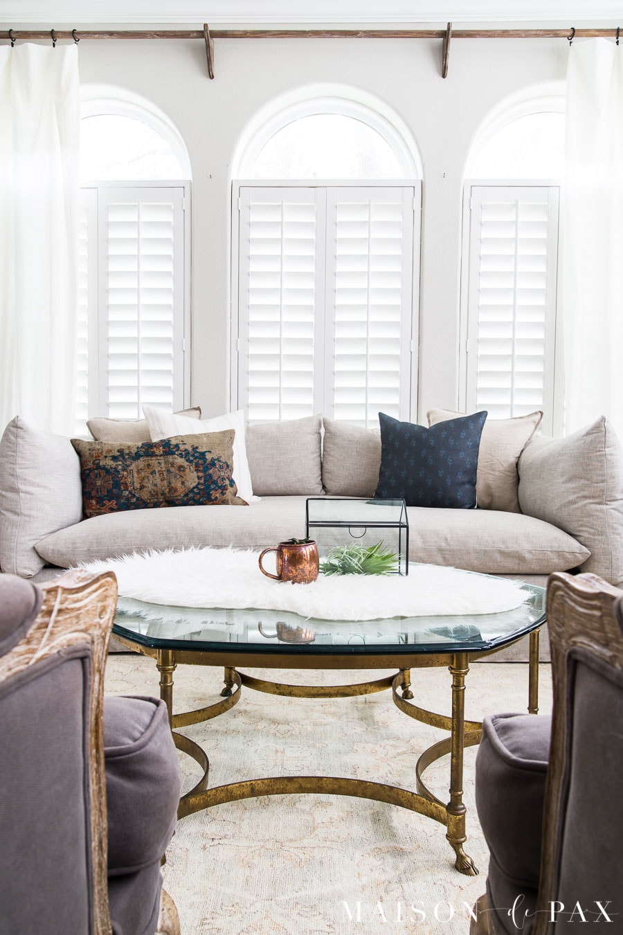 brass base coffee table with glass top and fur throw | Maison de Pax